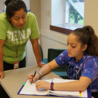 Image displays a BEAM mentor assisting a student on a problem.